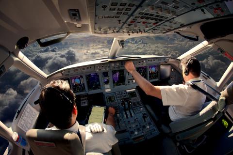 airplane cockpit with two pilots
