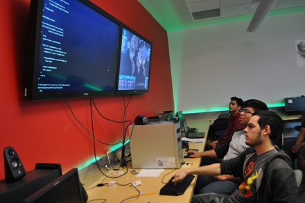 Cyber Battle Team members watch a monitor.