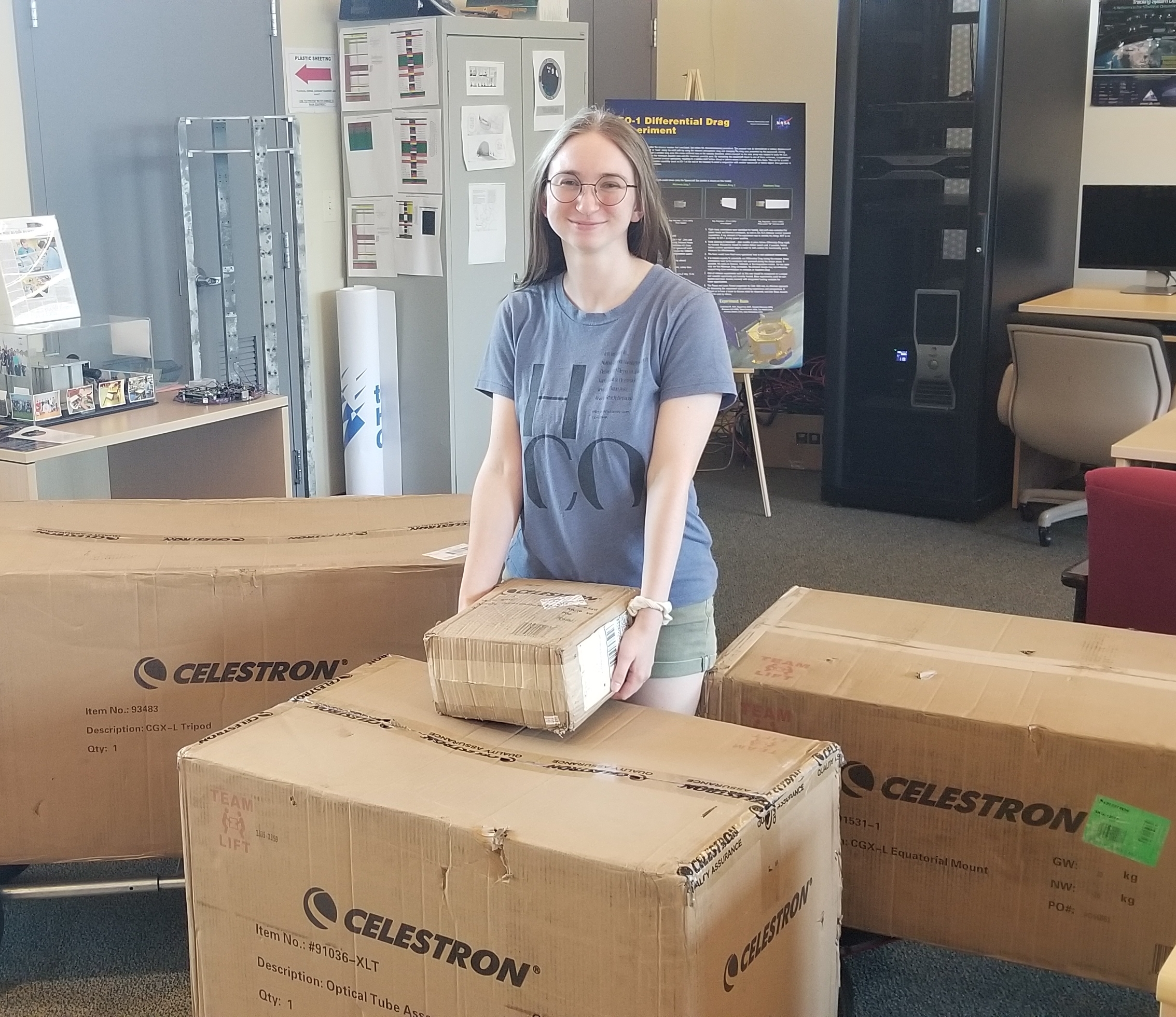 ALPHA Summer Intern Julianna Reese unloading telescope boxes