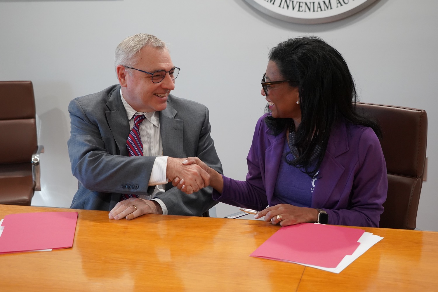 President Sims and Elisa Basnight Shake Hands at GAN MOU Signing