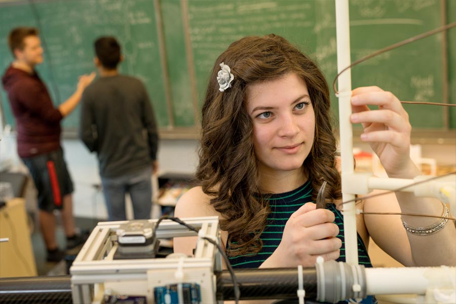 student working on antenna in lab